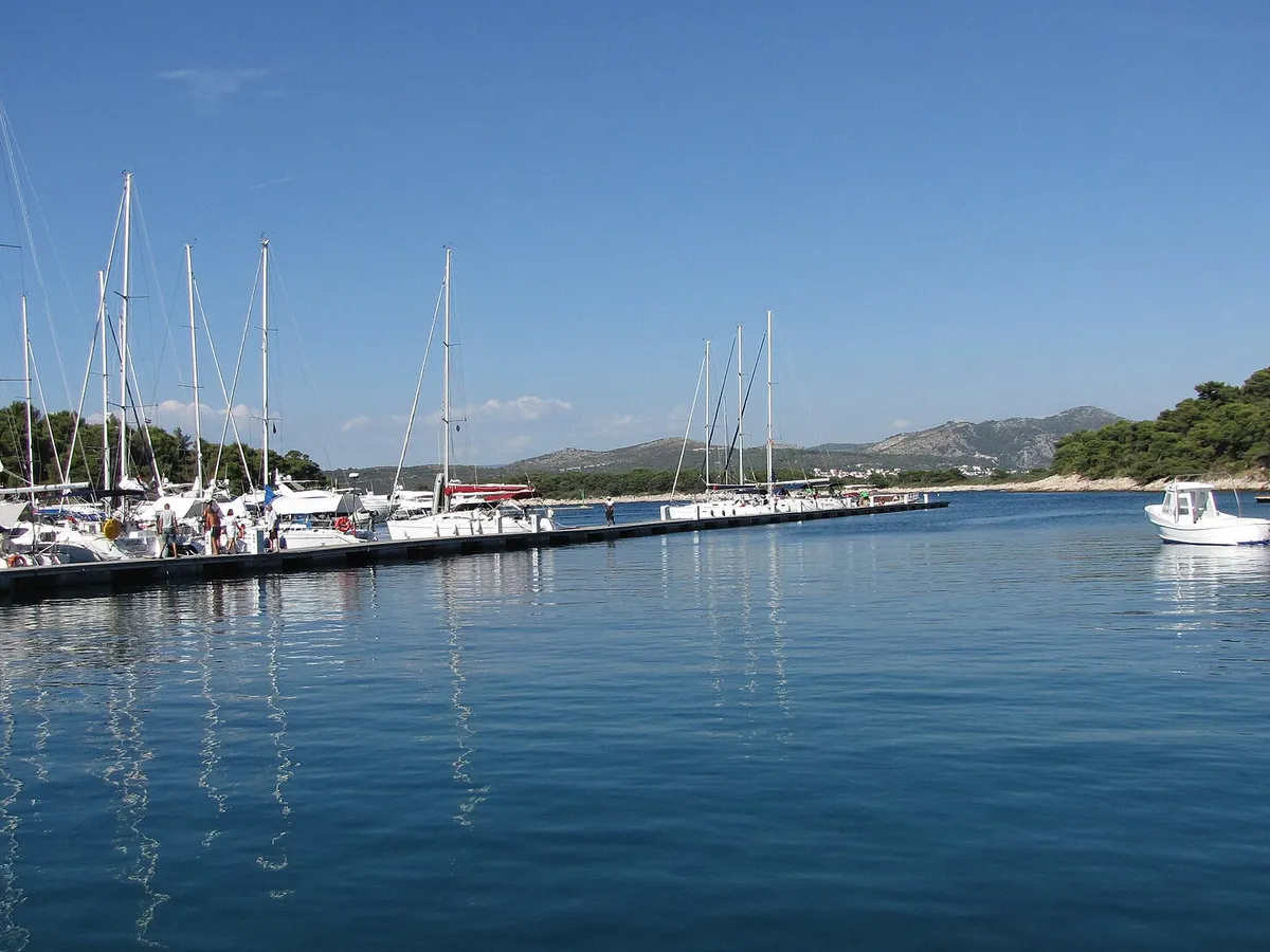 Yachts on the main pontoon of ACI Marina Palmižana in Luka Palmižana on Sveti Klement, looking out of the cove toward Hvar