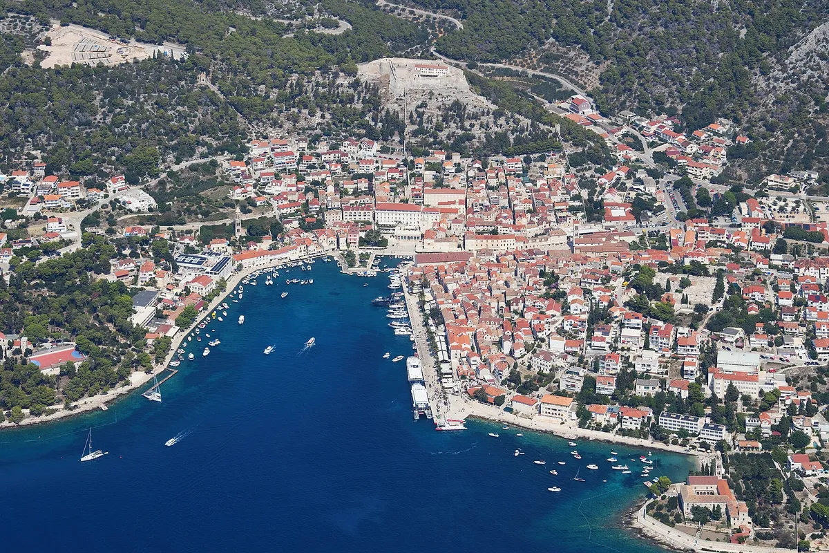 Aerial of Hvar town and its harbour inlet, seen from the south