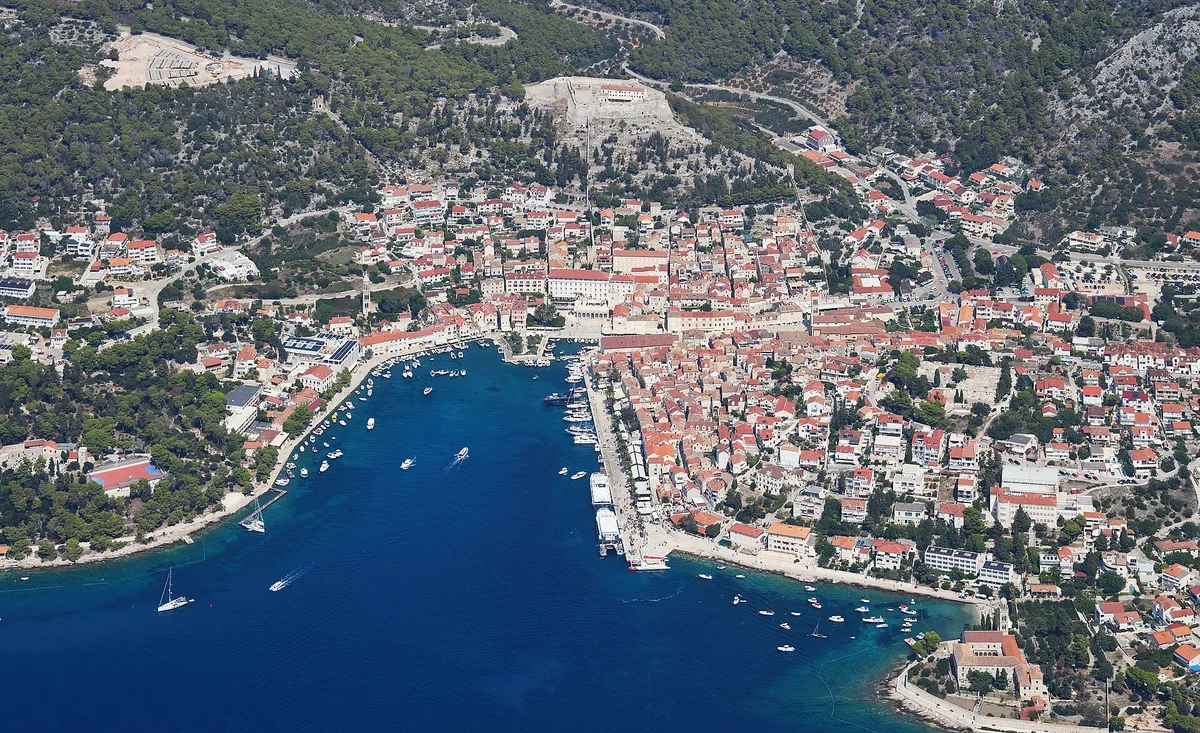 Aerial of Hvar town and its harbour inlet, seen from the south