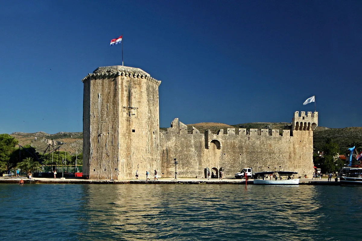 Kamerlengo fortress at the west end of the Trogir Riva, seen from the sea, with its tower and walls above the quay
