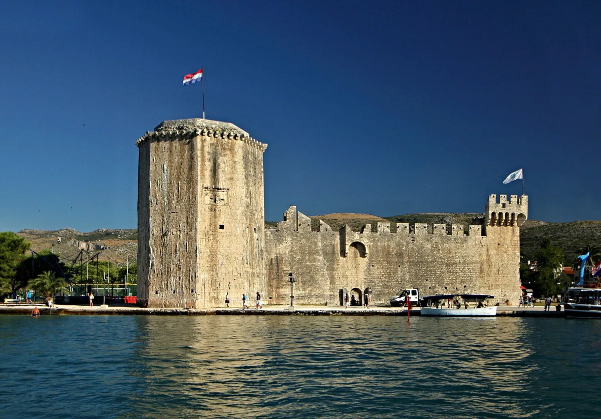 Kamerlengo fortress at the west end of the Trogir Riva, seen from the sea, with its tower and walls above the quay