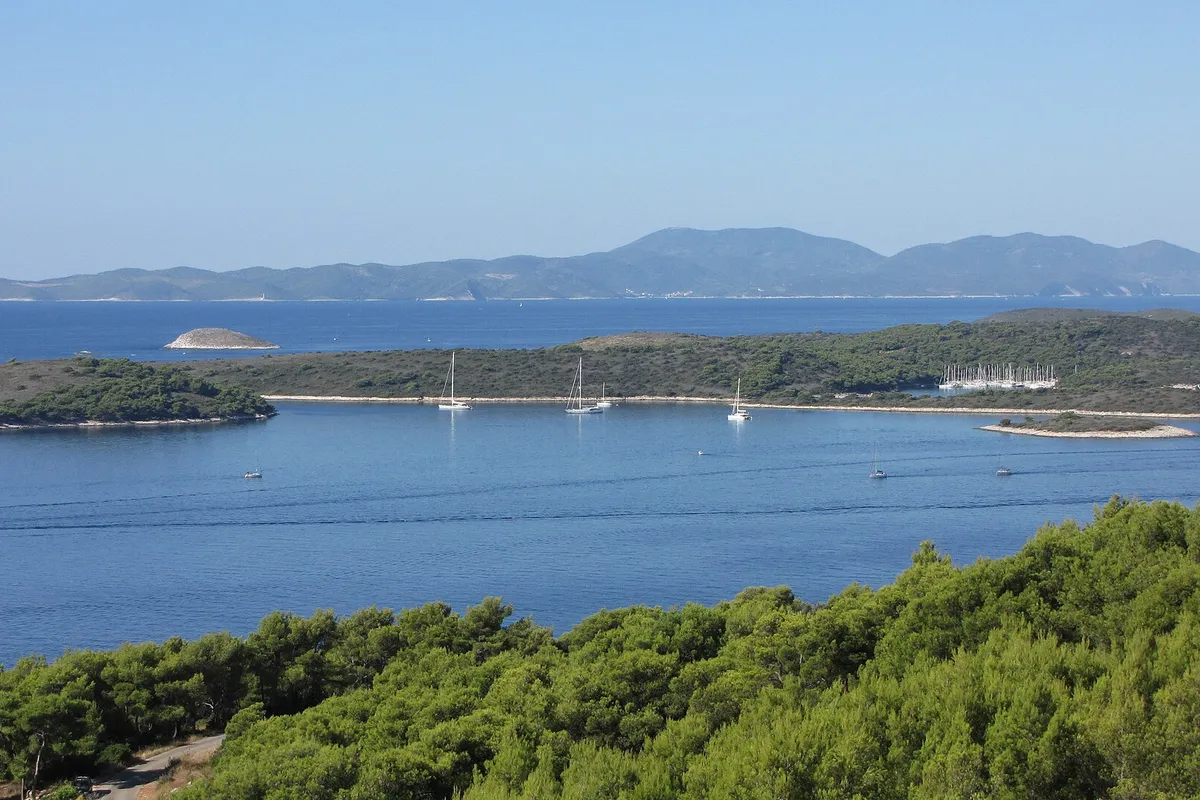 The Pakleni islands and ACI Marina Palmižana from the hills above Hvar town, yachts at anchor, Vis on the horizon
