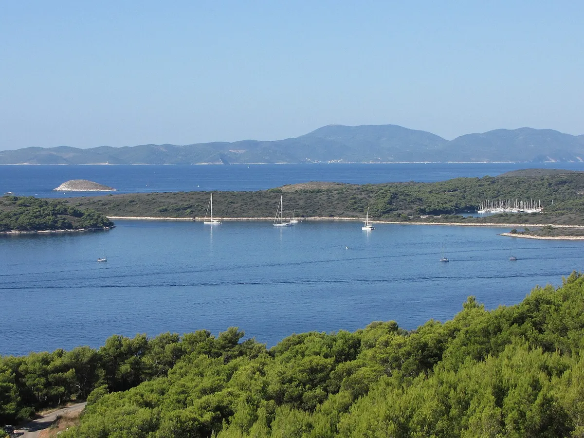 The Pakleni islands and ACI Marina Palmižana from the hills above Hvar town, yachts at anchor, Vis on the horizon