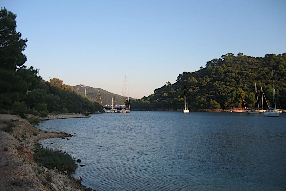 Yachts at their moorings in the bay at Pasadur on Lastovo on a calm evening, between wooded hills
