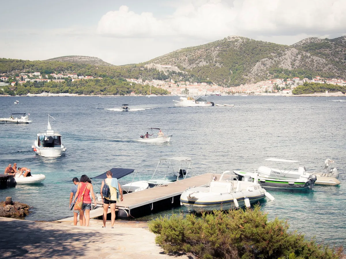 The taxi-boat pontoon in Stipanska bay on Marinkovac, looking across the channel to Hvar town and the Fortica