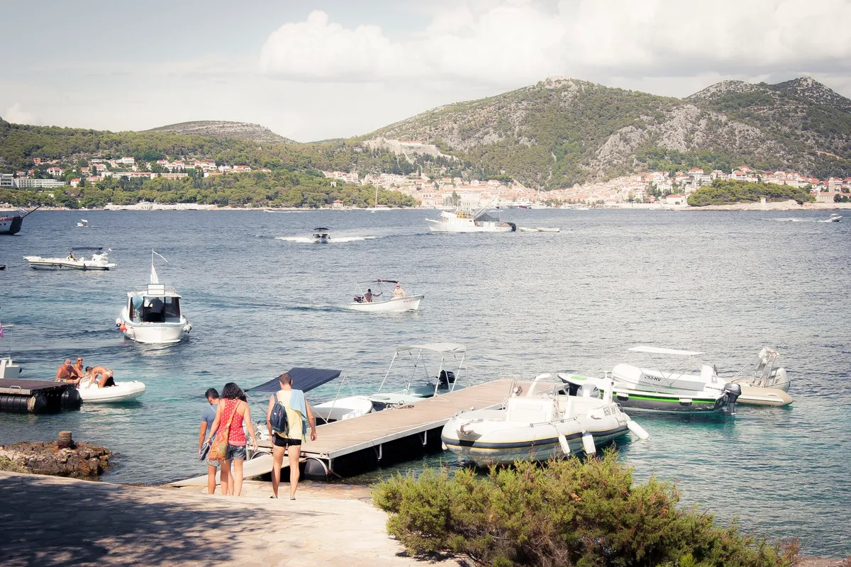 The taxi-boat pontoon in Stipanska bay on Marinkovac, looking across the channel to Hvar town and the Fortica