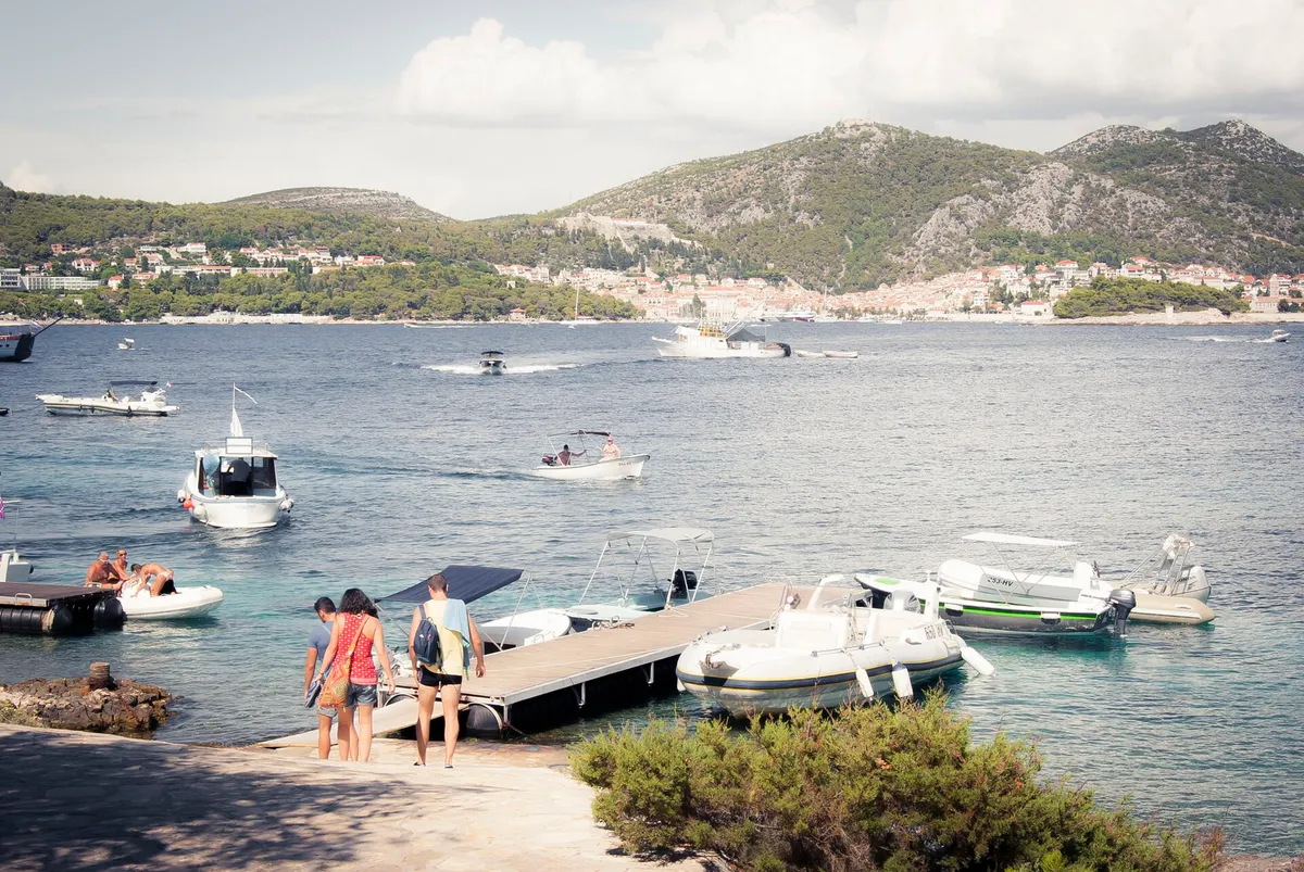 The taxi-boat pontoon in Stipanska bay on Marinkovac, looking across the channel to Hvar town and the Fortica