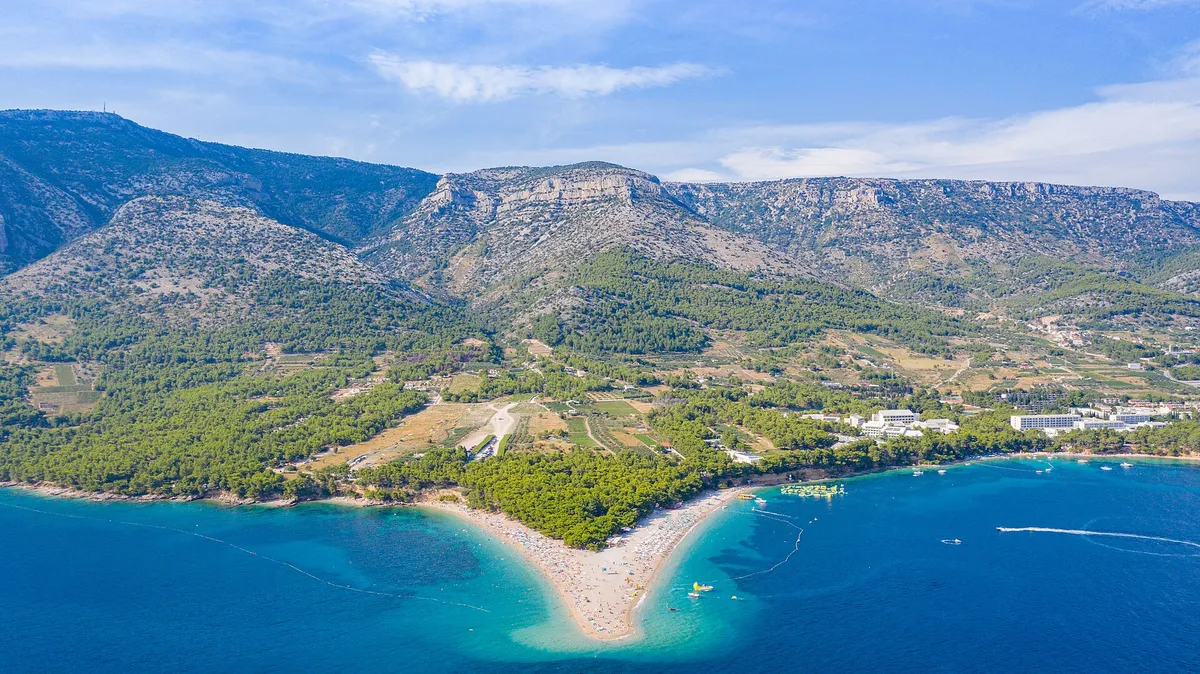 Aerial of Zlatni rat beach at Bol with Vidova Gora mountain behind