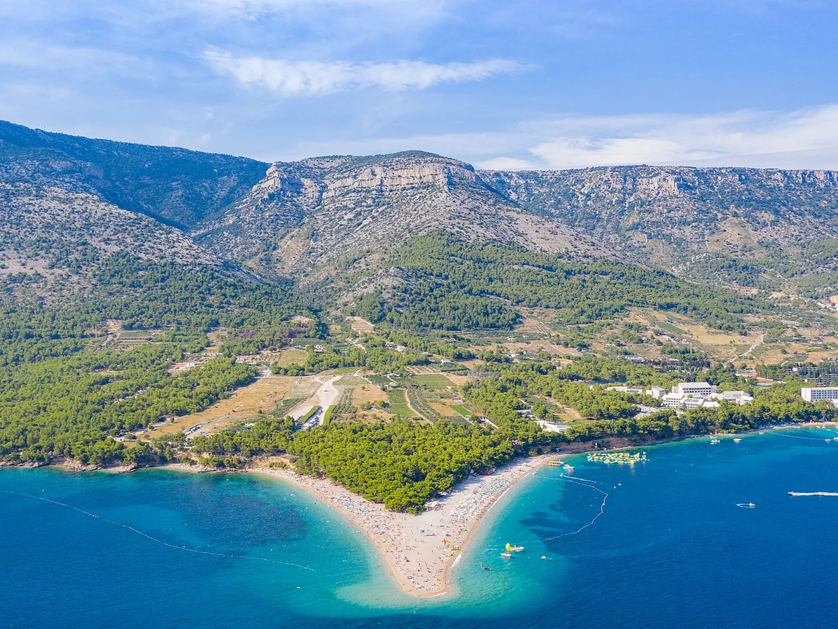 Aerial of Zlatni rat beach at Bol with Vidova Gora mountain behind